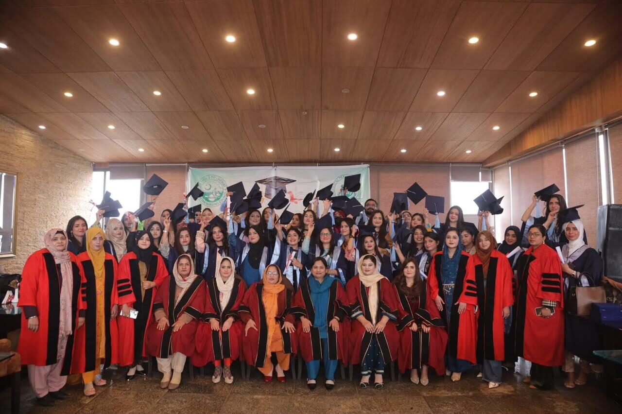 NACON convocation: faculty in academic gowns with the graduating class raising their caps