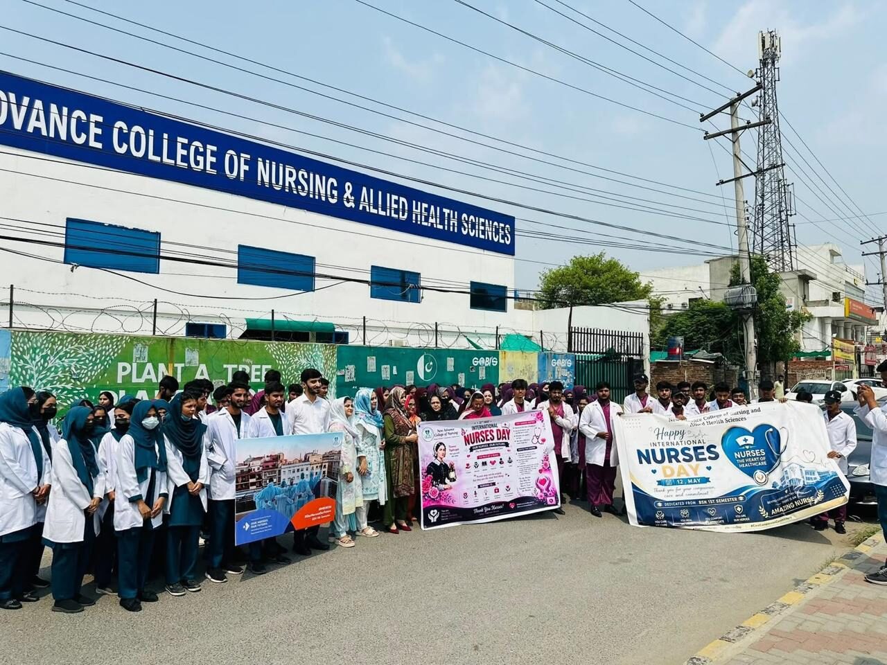 NACON students and staff gathered outside the college building in Johar Town with International Nurses Day banners